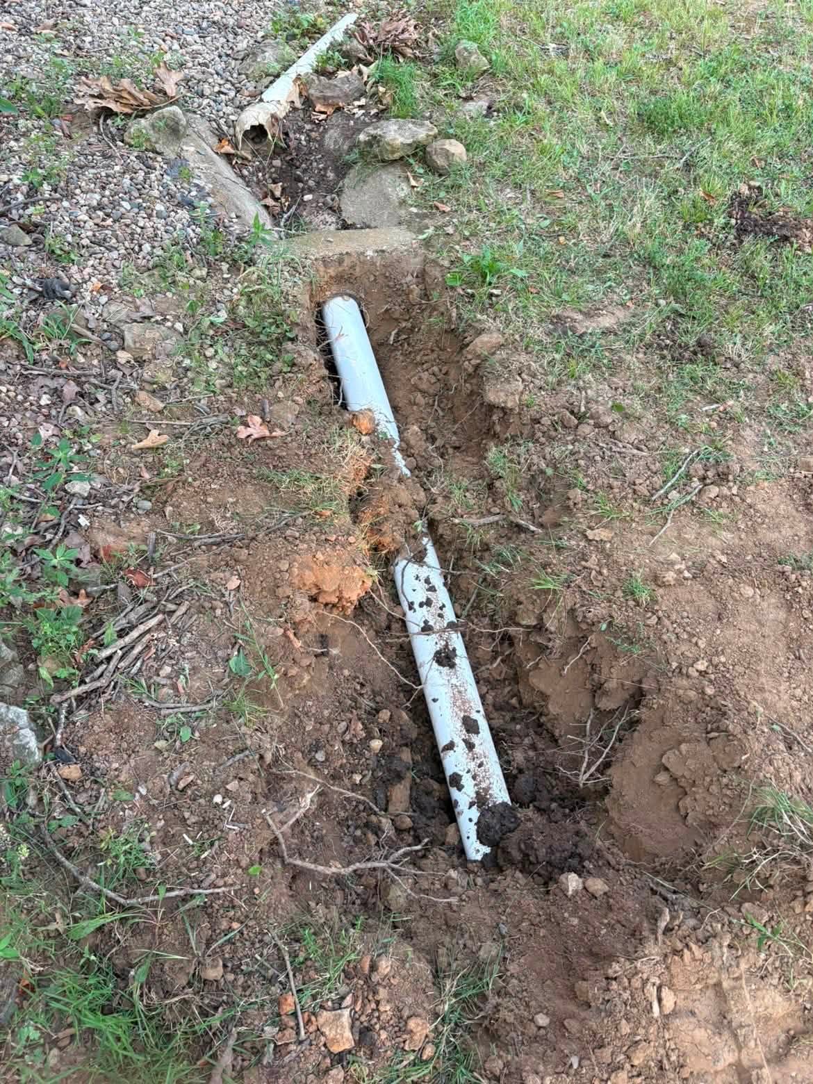 Sewer pipe installation in a narrow backyard trench in Richards, MO Sewer pipe installation in a narrow backyard trench in Richards, MO